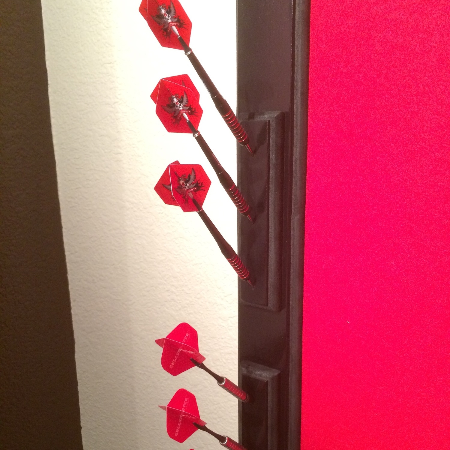 Finished dart holder on frame of cork board backstop