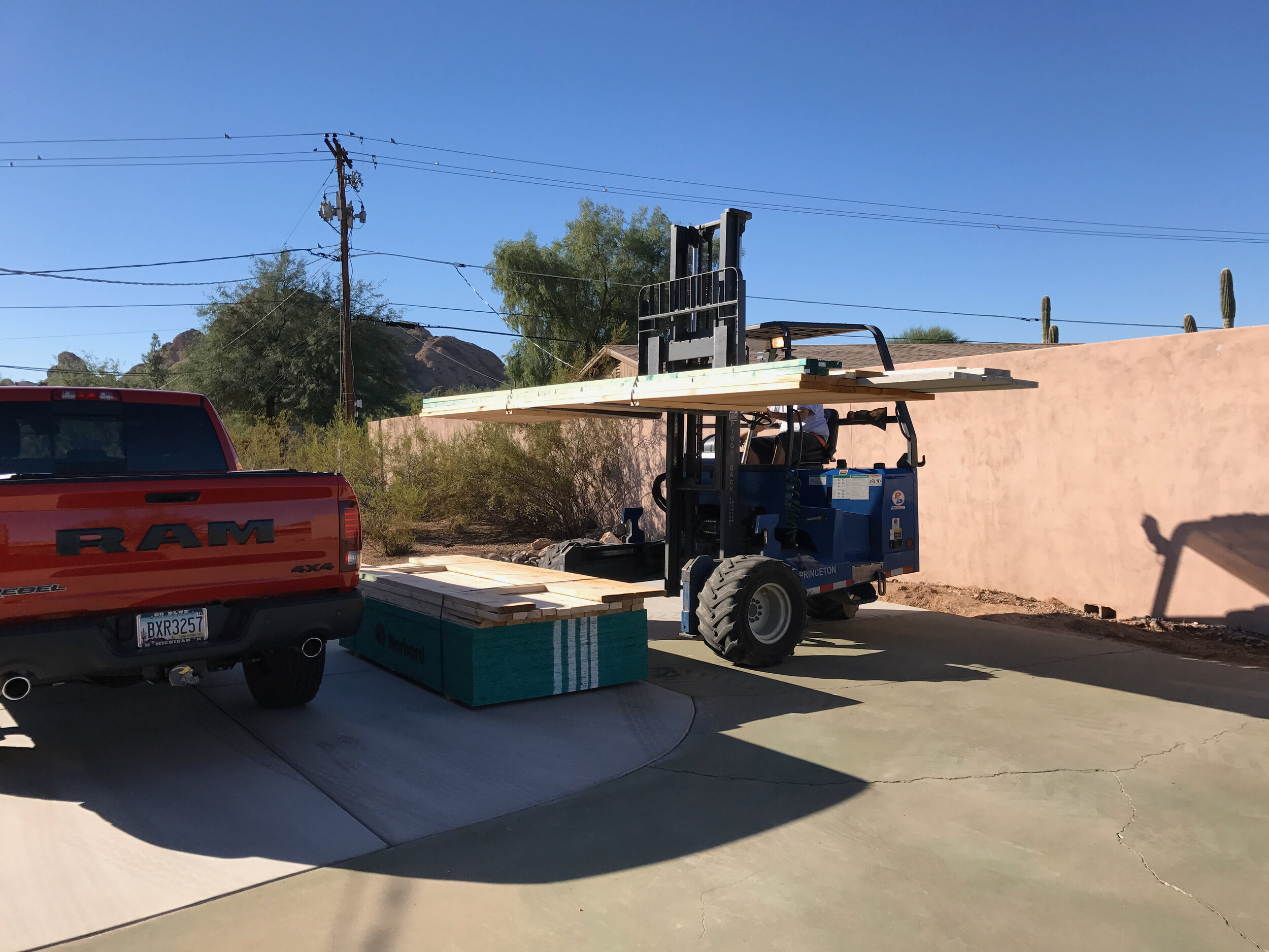 Watching the super-maneuverable forklift precisely position the shed material on the new driveway extension